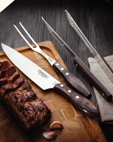 Promotional banner for Tramontina Churrasco BBQ props, featuring a logo on the left, a central photo of steak knives and carving tools on a cutting board with raw meat, and a red text panel on the right that reads 'Props to your BBQ skills!' and -40%  discount.